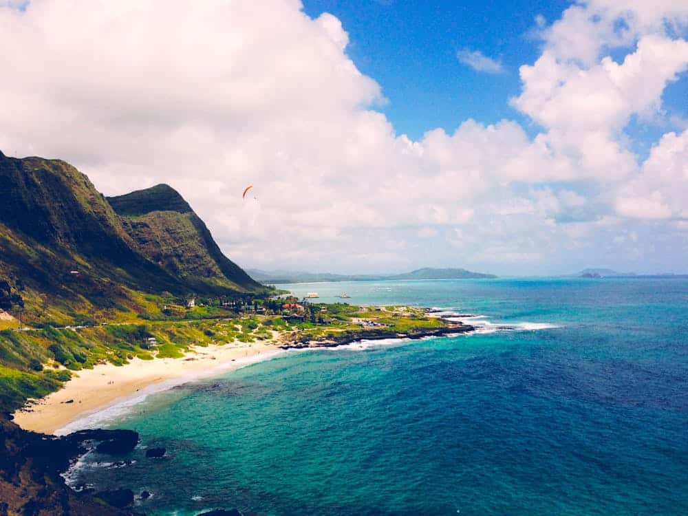 Aerial view of Hawaii beach with clear blue waters and lush mountains