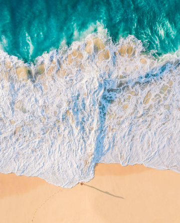 Turquoise water meeting a wide white-sand beach